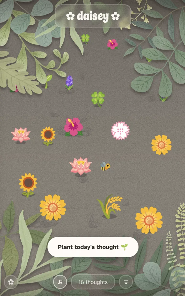 A phone showing a garden of flowers on soft grey ground, a bee
                  crossing the middle, framed by painted leaves.